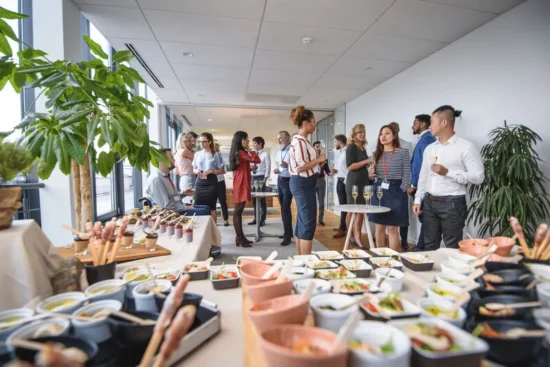 Professional catering event featuring diverse food platters, appetizers, and beverages served at a B2B networking function for foodservice industry professionals.