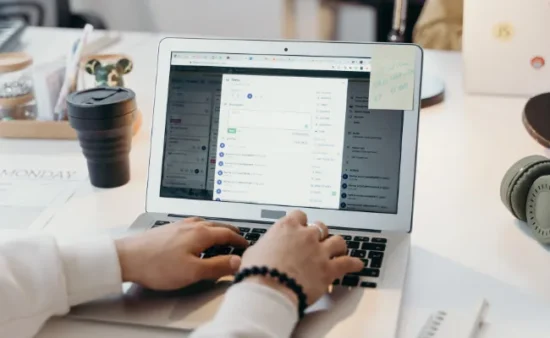 Food distributor using laptop to manage wholesale orders and inventory for commercial food supply operations.