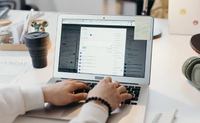 Food distributor using laptop to manage wholesale orders and inventory for commercial food supply operations.