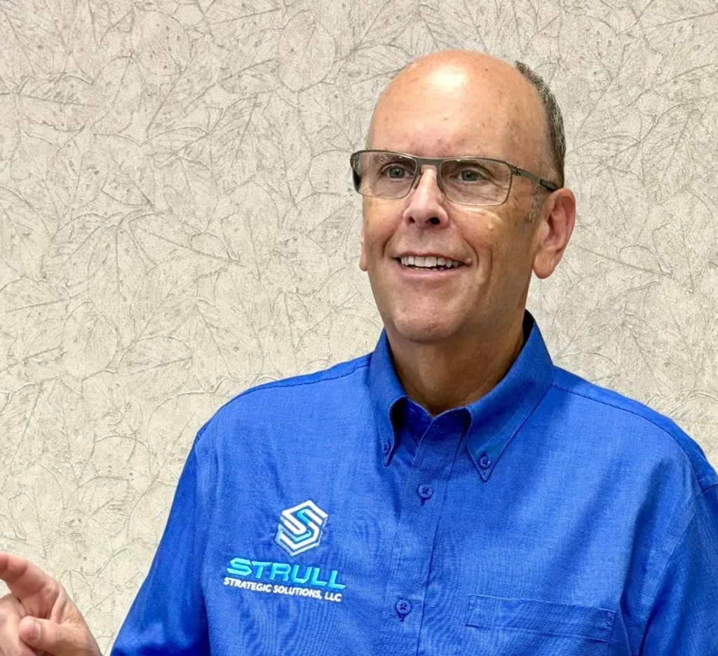 Professional man wearing Strull Strategic Solutions polo shirt, representing foodservice industry expertise and B2B food supply solutions.