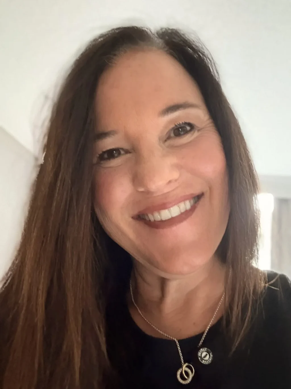 Professional headshot of a woman in business attire, ideal for food supply and wholesale distribution industry leadership.